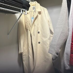 Ladies off white pants length coat.